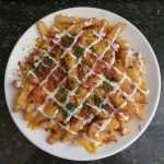 Loaded fries with bacon, chives, cilantro and ranch
